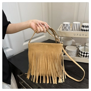 Detail of camel suede tote bag with dense fringe tassels in bohemian vintage style