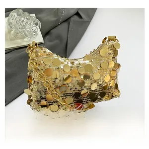 Close-up of luxury gold sequin crescent bag with chunky metallic chain strap detail