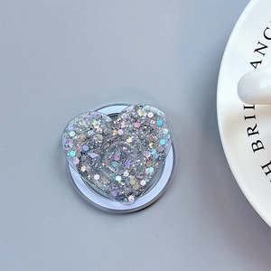 Macro view of heart-shaped glitter phone grip with silver sequins and telescopic base