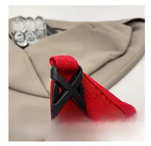 Detail of high-quality plastic buckle on red nylon crossbody dumpling bag