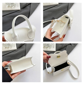 Détails d'un sac à main blanc en cuir grainé avec finitions dorées et compartiment interne