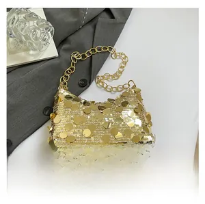 Detailed close-up of golden sequins and chunky metal chain strap on a stylish handbag