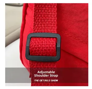 Close-up of adjustable black nylon strap and matte plastic buckle on red dumpling bag