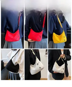Detail of multi-color nylon crescent crossbody bags in red, yellow, black and white