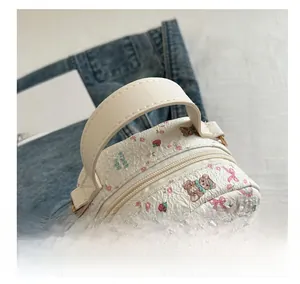 Detail view of printed backpack featuring cute bear patterns and gold metal logo
