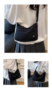 Close-up of black nylon dumpling bag featuring adjustable strap and silver M logo detail