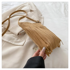 Detail of bohemian fringe crossbody bag with suede texture and adjustable shoulder strap