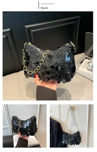 Close-up of black sequined crescent bag featuring a chunky gold chain and reflective finish