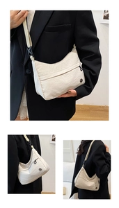 Macro detail of off-white nylon crossbody bag showing pleated texture and logo