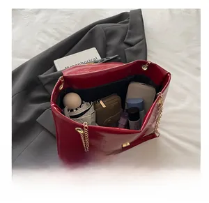 Detailed interior view of a red patent leather tote bag showing large storage capacity