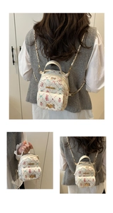 Detail of mini floral backpack with bunny print, chain strap, and fashion gold hardware