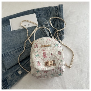 Detail of floral bear print mini backpack with golden twist lock and chain strap