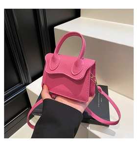 Close-up of litchi texture PU leather handbag with metal hook and detachable strap