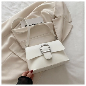 Detailed view of cream PU leather square bag with silver metal buckle and adjustable strap