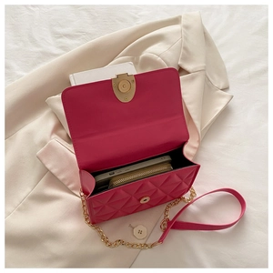Close-up of open magenta quilted bag showing interior space for phone and wallet