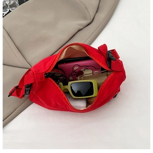 Top view of red crescent crossbody bag showing large capacity and internal storage