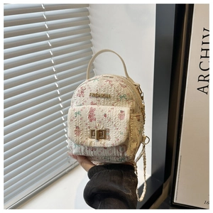 Detail of cartoon bunny print handbag with pearl chain and golden metal clasp