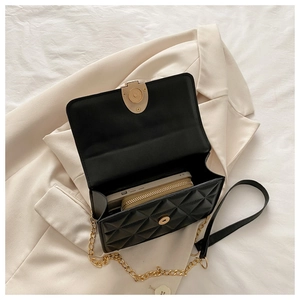Detail shot of the black quilted crossbody bag showing spacious interior for smartphone