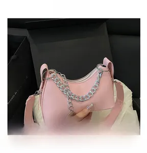 Detail of pink PU leather crescent bag with silver chunky chain and adjustable strap
