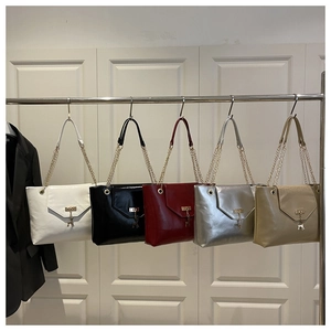 Detail view of colorful envelope shoulder bags with deer pendants and chain straps