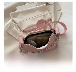 Pink leather handbag interior showing storage for phone, wallet and cosmetics compact