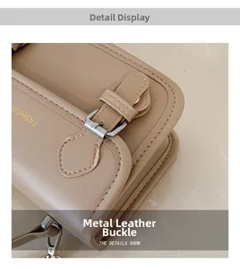 Detail of light brown leather bag with lychee texture and silver metal buckle