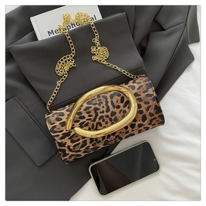 Detail of leopard print leather bag with gold chunky chain strap and metal handle