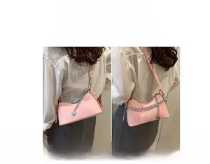 Pink leather underarm bag with silver chain and adjustable strap showing two ways to wear