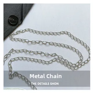 Macro shot of a high-gloss silver hardware chain strap with flat oval metal links