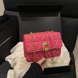 Chic pink quilted leather flap bag with gold horseshoe lock on black gift box