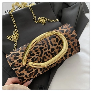 Close-up of leopard print clutch with large gold oval buckle and metal chain strap
