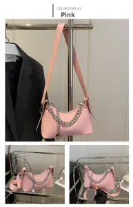 Pink crescent shoulder bag with bold silver metal chain and smooth faux leather detail