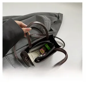Interior view showing the storage capacity of this vintage woven leather crossbody bag