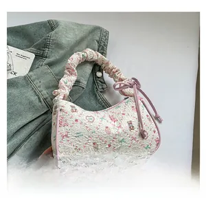 Detail of cream jacquard tote bag featuring floral bear patterns and pink bow accents