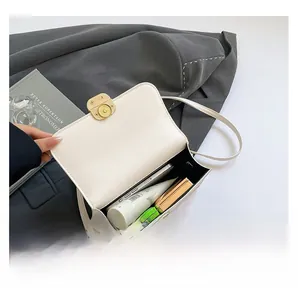 Interior capacity of the white leather crossbody bag with phone, balm and lipstick