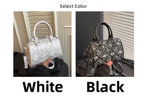 Detail of grid patterned cylinder handbags in black and white with adjustable straps