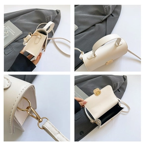 Detailoverzicht van de witte lederen tas met magneetsluiting en metalen haken