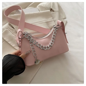 Detail of pink crescent bag featuring silver chunky chain and smooth matte leather finish