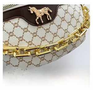 Close-up of premium textured ivory saddle bag with vintage monogram and gold horse logo