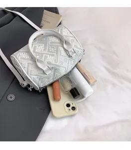 Detailed interior of checkered bucket bag showing spacious storage for essentials