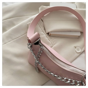 Detail of pink PU shoulder bag with thick silver chain link and smooth texture