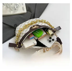 Interior view of beige saddle bag showing storage for phone, wallet and cosmetics