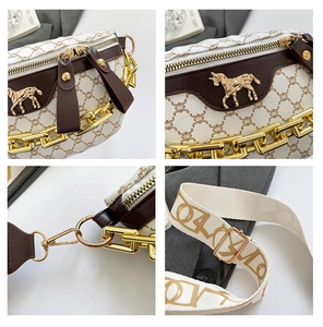 Detail of white leather shoulder bag featuring gold horse hardware and chunky metal chain