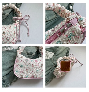 Detail of ruffled handle and cute cartoon patterns on a pink fabric shoulder bag