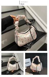 Detail showing white patterned tote bag with cute bear prints and black bow decoration