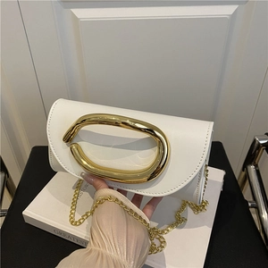 White glossy leather flap bag with artistic gold metal ring handle and chain strap