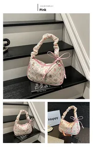 Detailed macro of pink shoulder bag with cartoon embossing and ruffled strap design