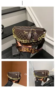 Detail of coffee printed chest bag with golden horse buckle and wide jacquard strap
