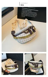 Detail of white saddle bag with golden chain and horse emblem on embroidered strap