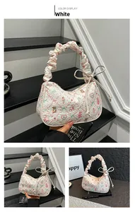 Detail of white quilted tote bag with teddy bear prints and ruffled cloud handle